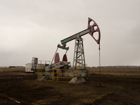 The beam pumping unit is homework, sunset in oil field