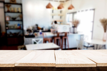 Selected focus empty brown wooden table and Coffee shop or restaurant blur background with bokeh image. for your photomontage or product display.