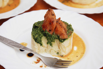 Roasted Chicken Breast and Mashed Potatoes with Spinach Sauce in White Plate. top view.