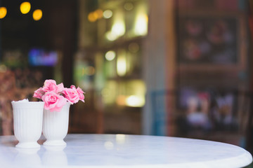 Naklejka na ściany i meble flower with tables in coffee shop , bokeh background