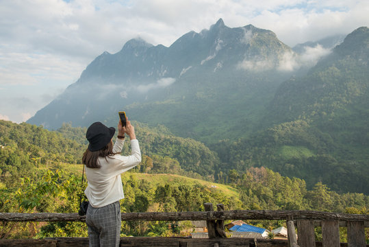 Asian women travel and taking a photos of Doi Luang Chiang Dao the 3rd highest mountains peak (2,275 metres) in Thailand.