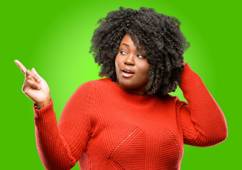 Beautiful african woman pointing away side with his finger