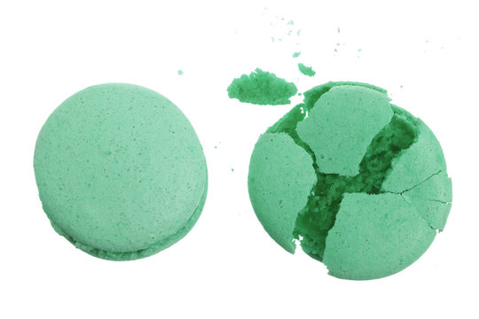 broken green macarons isolated on white background closeup