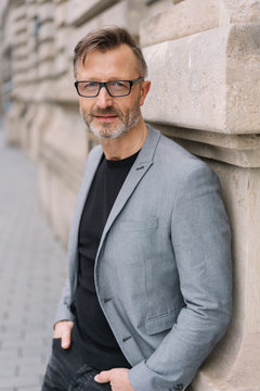 Street portrait of mature man wearing grey jacket