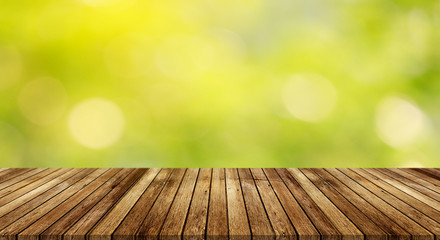 Wood table top on bokeh abstract green background for montage or display or products 