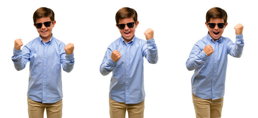 Handsome toddler child with green eyes happy and excited celebrating victory expressing big success, power, energy and positive emotions. Celebrates new job joyful