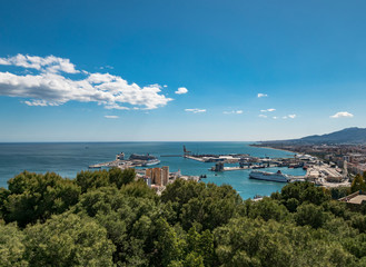 Obraz premium View from the Gibralfaro castle on a sunny day. Panorama view of the city skyline, the port and cruise ships