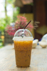 Ice coffee on a wooden table