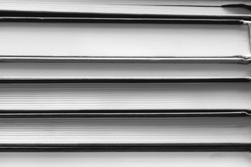 Close-up of a stack of books. Black and white photography.