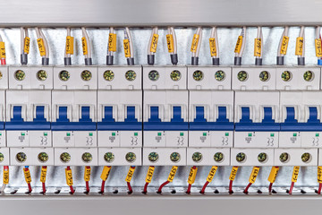 Range of electrical modular circuit breakers in electrical Cabinet. Neat and high-tech Assembly of switchboards. The wires or cables are connected to the switches and laid in the cable channels.