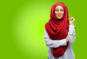 Young arab woman wearing hijab confident and happy with a big natural smile laughing