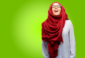 Young arab woman wearing hijab confident and happy with a big natural smile laughing