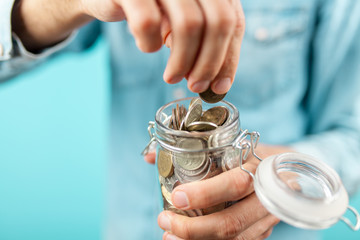 Man holding a coin jar