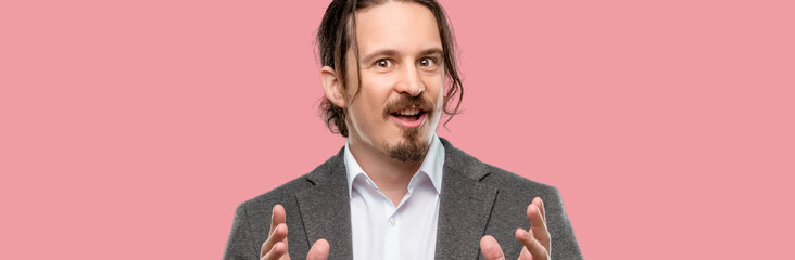 Handsome young man happy and surprised cheering expressing wow gesture