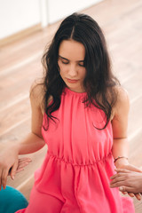 Woman meditating practicing yoga with friends