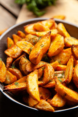 Baked potato fries on wooden table