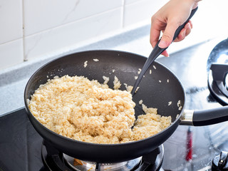 Stir frying salted rice used in zongzi or rice dumpling on Dragon Boat Festival, Asian traditional food