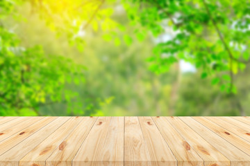 Wood floor with blurred trees of nature park background