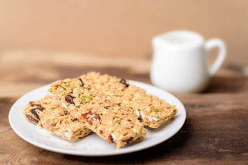 Snack bar or energy bar on white dish, healthy food