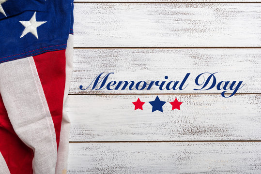 United states flag on white, weathered clapboard background with memorial day greeting