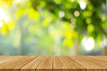 Wood floor with blurred trees of nature park background and summer season, product display montage 
