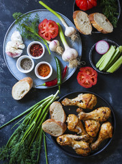 Vegetables and herbs for a picnic. Marinated chicken legs. Top view.