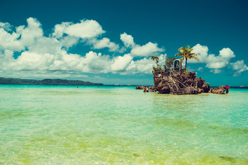Transparent shallow water. Travel to Philippines. Summer luxury vacation. Boracay paradise island. White beach. Seaview. Tourism concept. Willy's rock. Religion, tourist landmark. Copy space