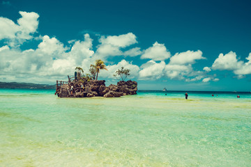 Transparent shallow water. Travel to Philippines. Summer luxury vacation. Boracay paradise island. White beach. Seaview. Tourism concept. Willy's rock. Religion, tourist landmark. Place for text