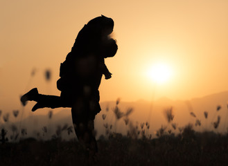 Silhouette of a couple in love on a sunset tropical background.