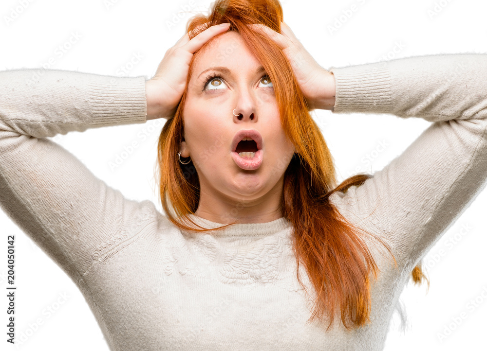 Sticker Beautiful young redhead woman stressful keeping hands on head, terrified in panic, shouting isolated over white background