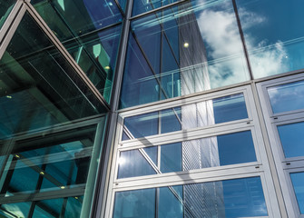 Obraz premium The glass architecture in city against a sky