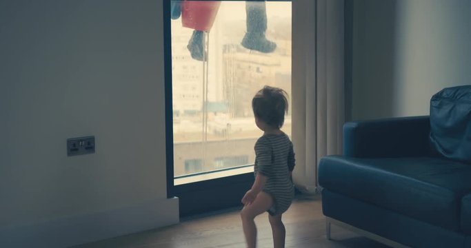 Little boy starled by window cleaner in city