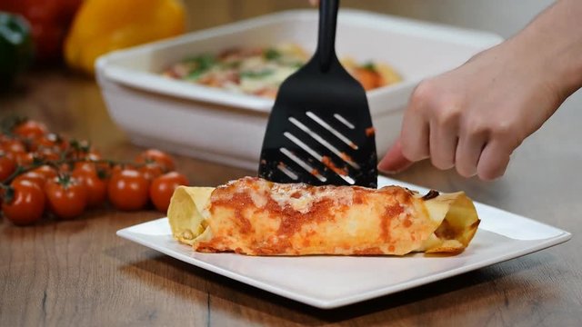 Homemade chicken enchiladas in a white plate.