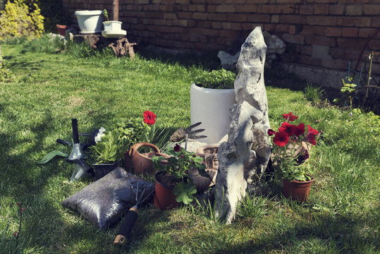 Flowers Soil Tools And Solar Lamps In A Garden