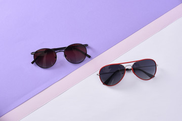 sunglasses / eyewear on pastel color paper background 