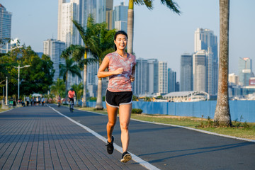 Portrait og beautifful  asian woman in rose t-shirt with bottle of water in her hand. Sporty life concept