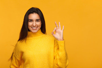 Charming girl showing OK gesture