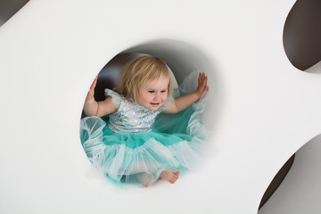  A LITTLE GIRL IN A BLUE DRESS SMILES