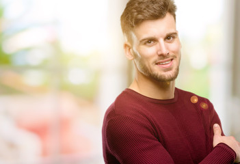 Fototapeta premium Handsome young man confident and happy with a big natural smile laughing, natural expression