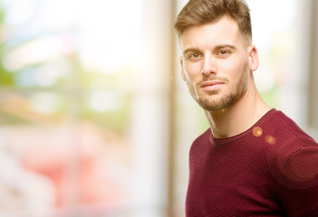 Naklejka premium Handsome young man confident and happy with a big natural smile inviting to enter