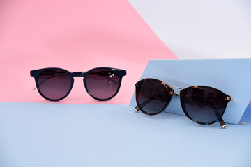 sunglasses / eyewear on pastel color paper background 