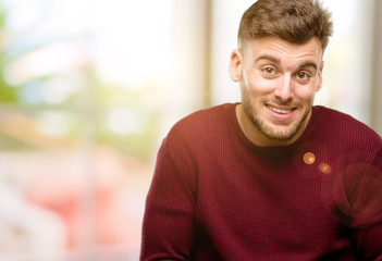 Naklejka premium Handsome young man confident and happy with a big natural smile