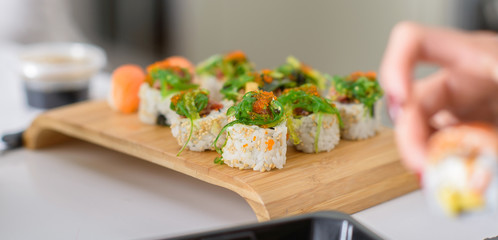 Delicious sushi, japanese food with raw fish, avocado and rice