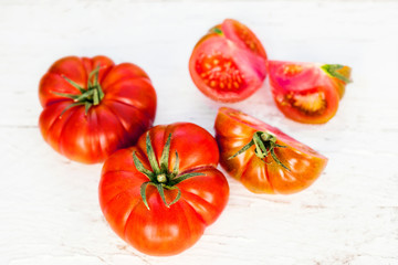 Close-up of fresh, ripe tomatoes on white wood background with copy space. top view. Food background.