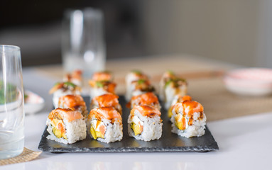 Delicious sushi, japanese food with raw fish, avocado and rice