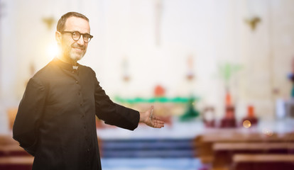 Priest religion man confident and happy with a big natural smile inviting to enter at church