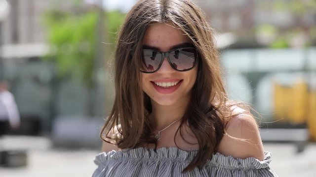 Elegant brunette cute woman model smiling in city street