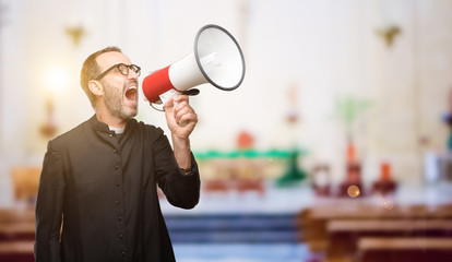 Priest religion man communicates shouting loud holding a megaphone, expressing success and positive...