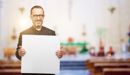 Priest religion man holding blank advertising banner, good poster for ad, offer or announcement, big paper billboard at church
