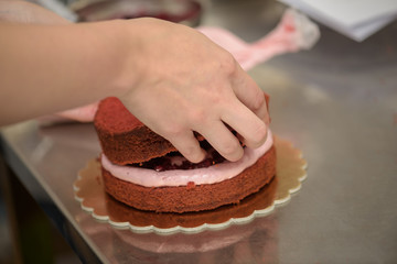 Arranging a red berries cake